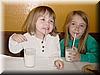 2002-03-10a Allie and Kylah happy with milk and scones.jpg